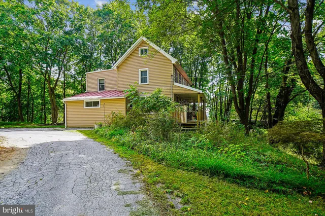 a view of backyard of house with green space