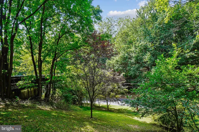 a house with green field in front of it