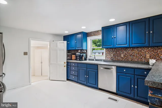 a kitchen with cabinets a sink and appliances