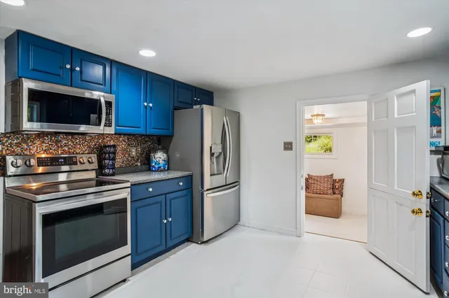 a kitchen with stainless steel appliances granite countertop a refrigerator stove and microwave