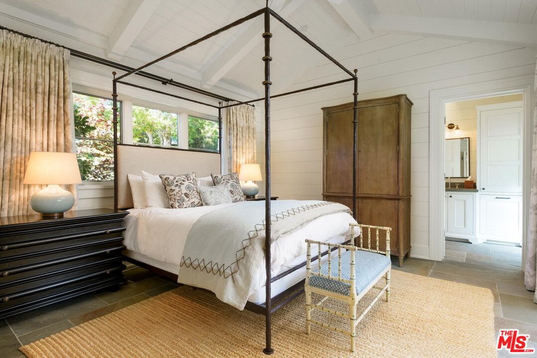 1779 Glen Oaks Drive Montecito, CA 93108 - Photo 13 of 32 a bedroom with a bed and wooden floor