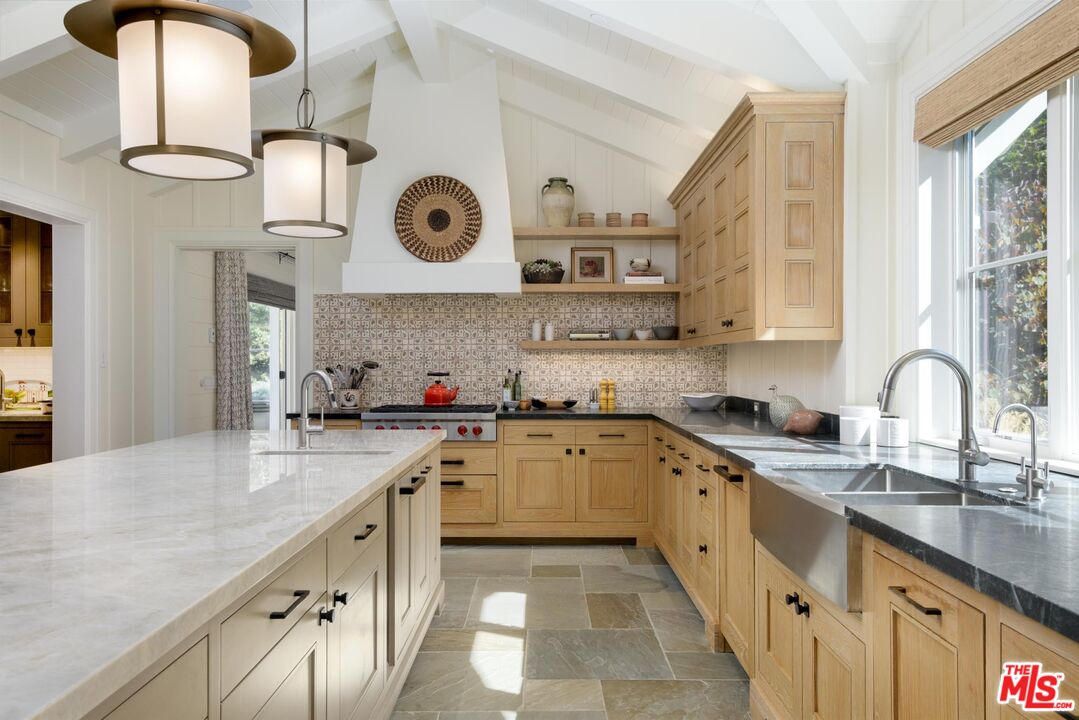 1779 Glen Oaks Drive Montecito, CA 93108 - Photo 8 of 32 a large kitchen with stainless steel appliances granite countertop a sink and cabinets with wooden floor