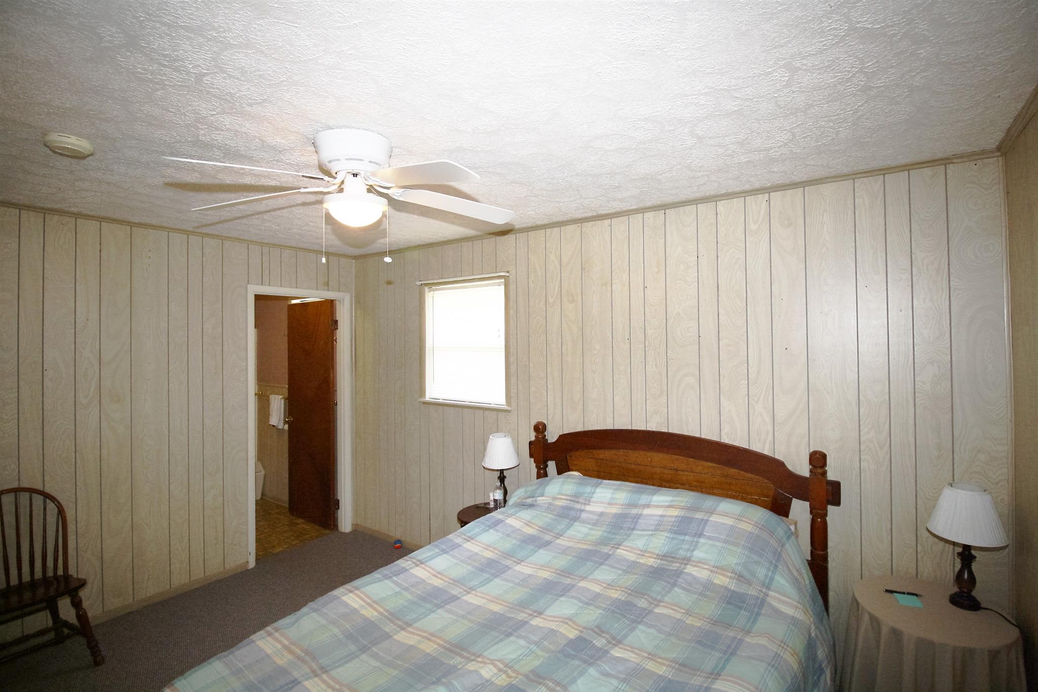 17550 Witty Mill Road Elkmont, AL 35620 - Photo 8 of 27 a bedroom with a bed and a chandelier