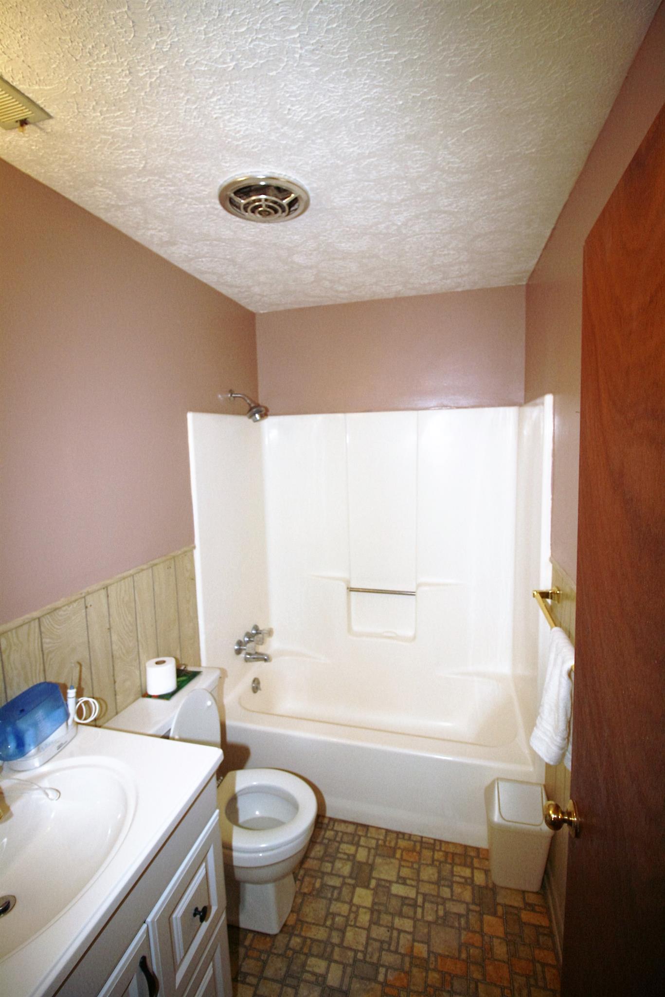 17550 Witty Mill Road Elkmont, AL 35620 - Photo 9 of 27 a bathroom with a sink a toilet and tub