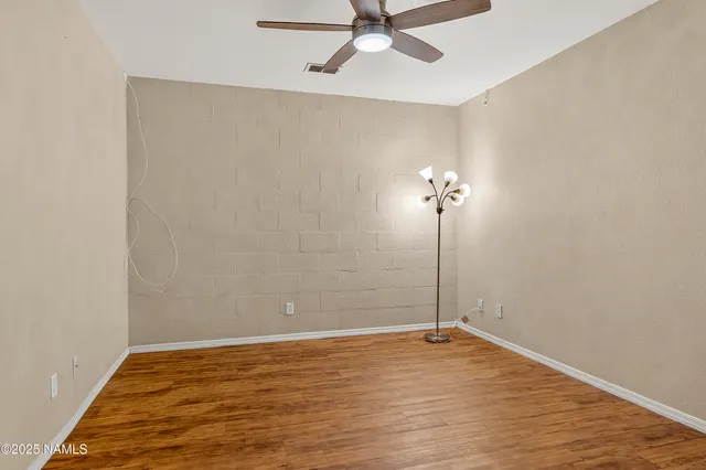 a view of a room with wooden floor