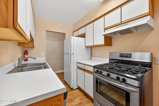 a kitchen with stove and cabinets