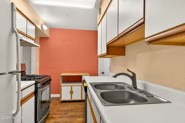 a kitchen that has a sink and a stove