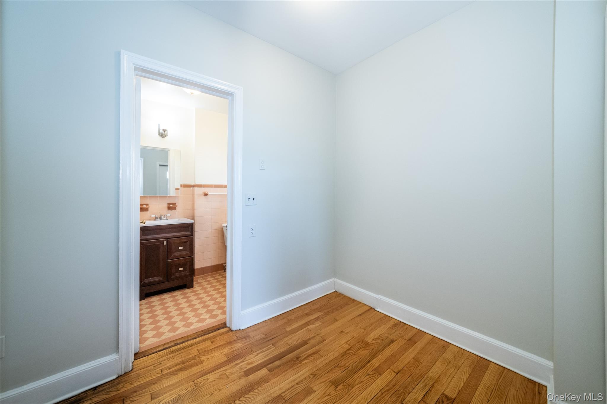 7 Alpha Place, Unit FIRST New Rochelle, NY 10805 - Photo 12 of 25 Empty room with light wood-style floors and tile walls