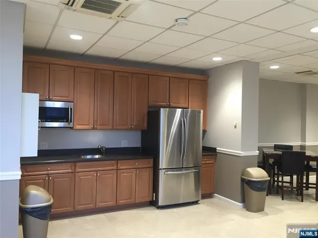 a kitchen with stainless steel appliances granite countertop a refrigerator sink and stove