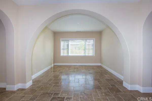 a living room with stainless steel appliances kitchen island granite countertop a cabinets and a view of kitchen