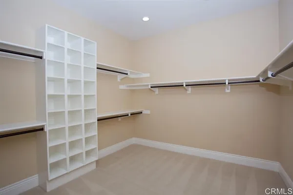 a spacious bathroom with a tub sink and mirror