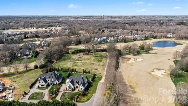 an aerial view of a house with yard swimming pool and outdoor seating