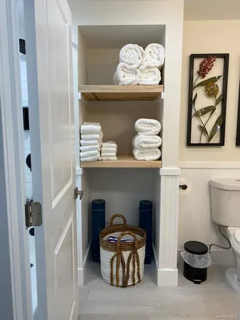 a bathroom with a granite countertop toilet sink and mirror