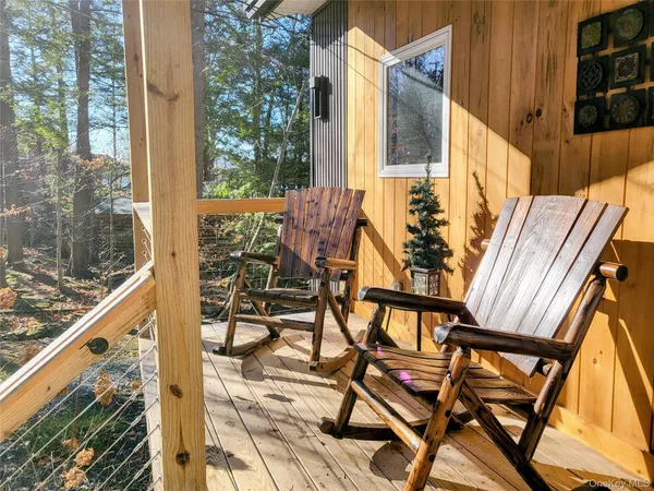 a view of balcony with wooden floor and fence