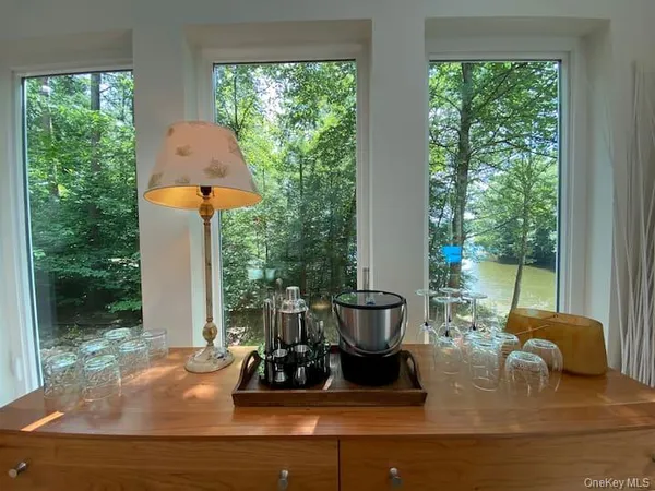 a living room with patio furniture and a potted plant