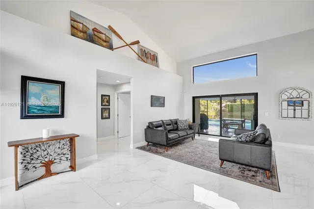a living room with furniture window and a flat screen tv