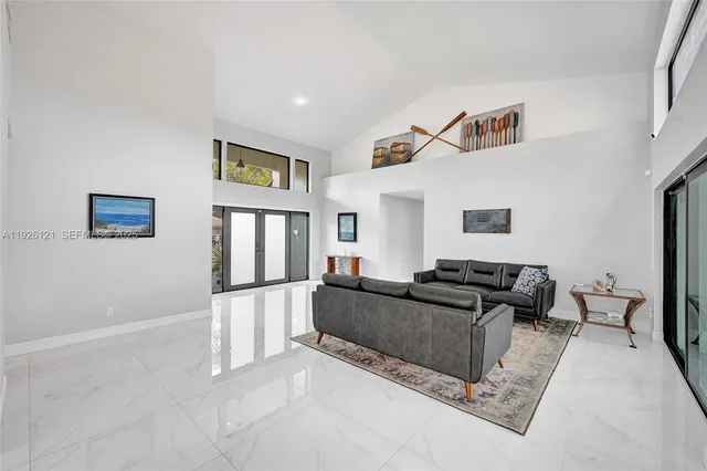 a kitchen with stainless steel appliances granite countertop a sink a stove and cabinets