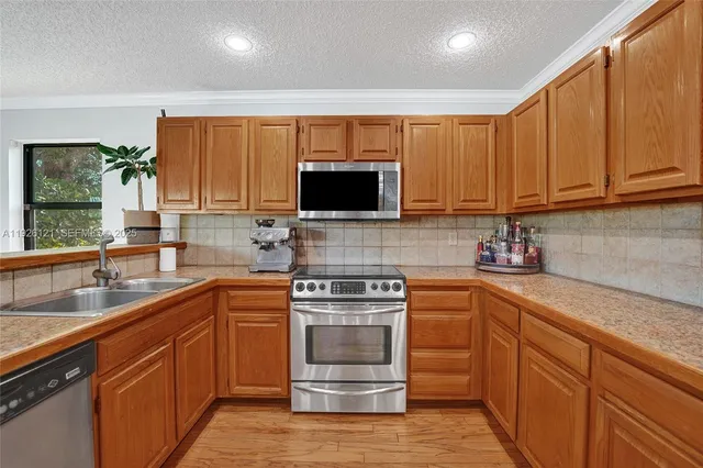 a spacious bedroom with a bed a dresser and next to a window