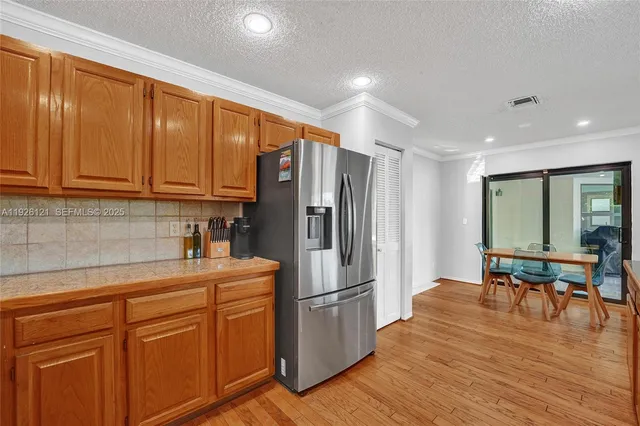a living room with furniture and a view of kitchen