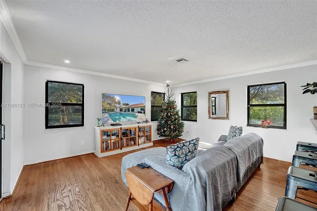 a living room with furniture and large windows