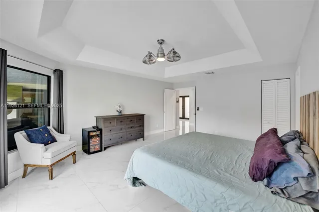 a bathroom with a granite countertop sink a toilet a mirror and shower