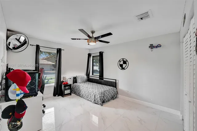 a dining room with furniture and a floor to ceiling window