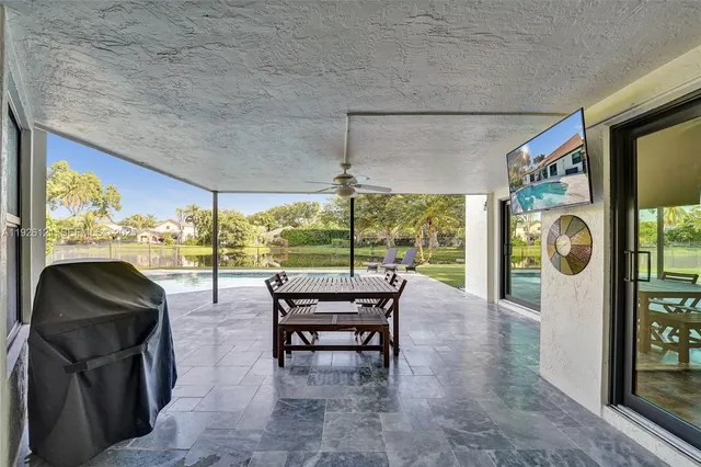 a view of a house with backyard porch and sitting area