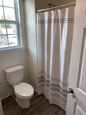489 Ridge Road Bolingbrook, IL 60440 - Photo 17 of 34 a bathroom with a toilet and a shower curtain