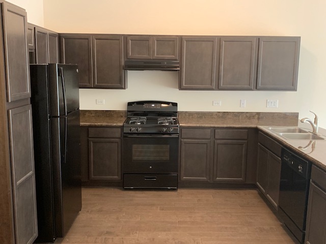 489 Ridge Road Bolingbrook, IL 60440 - Photo 23 of 34 a kitchen with a sink stove and refrigerator