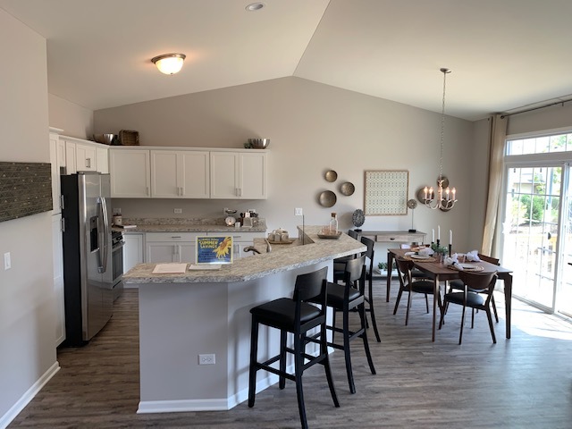 489 Ridge Road Bolingbrook, IL 60440 - Photo 8 of 34 a living room with stainless steel appliances kitchen island granite countertop furniture and wooden floor