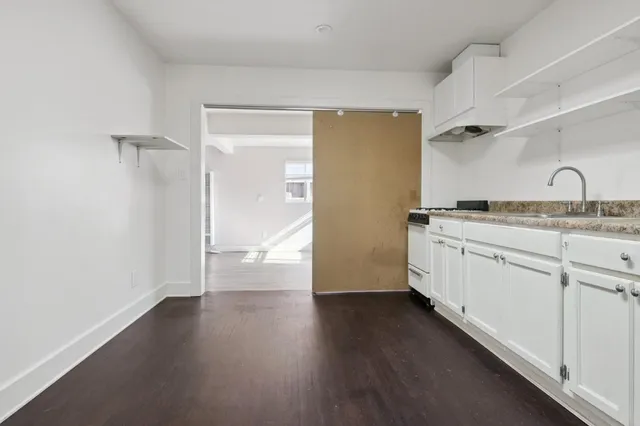 a view of a kitchen with wooden floor