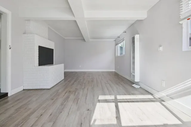 a view of a room with wooden floor