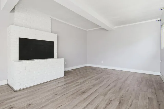 a room with wooden floor and white wall