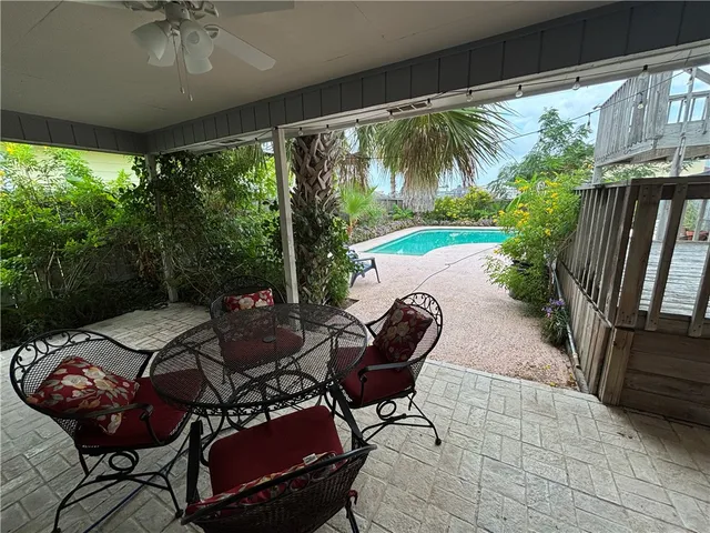 a view of a patio with table and chairs potted plants with wooden floor
