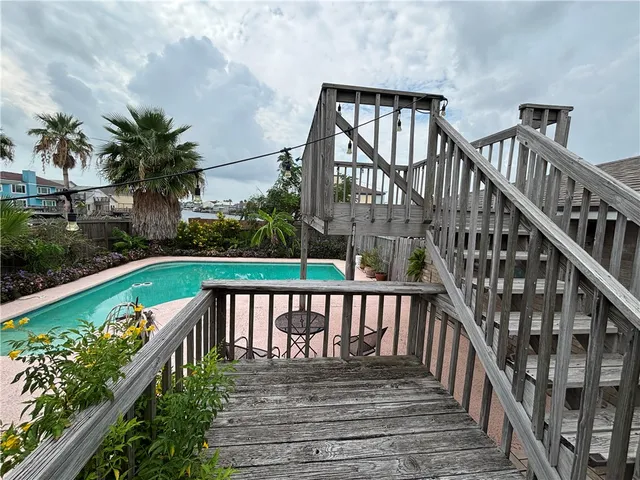 a view of a house with backyard and deck