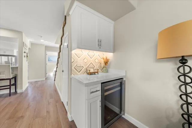 a view of a hallway with mirror and a window