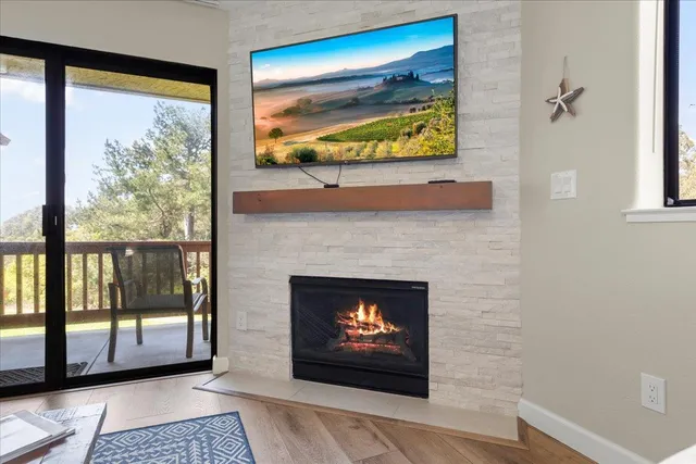 a living room with fireplace and a flat screen tv