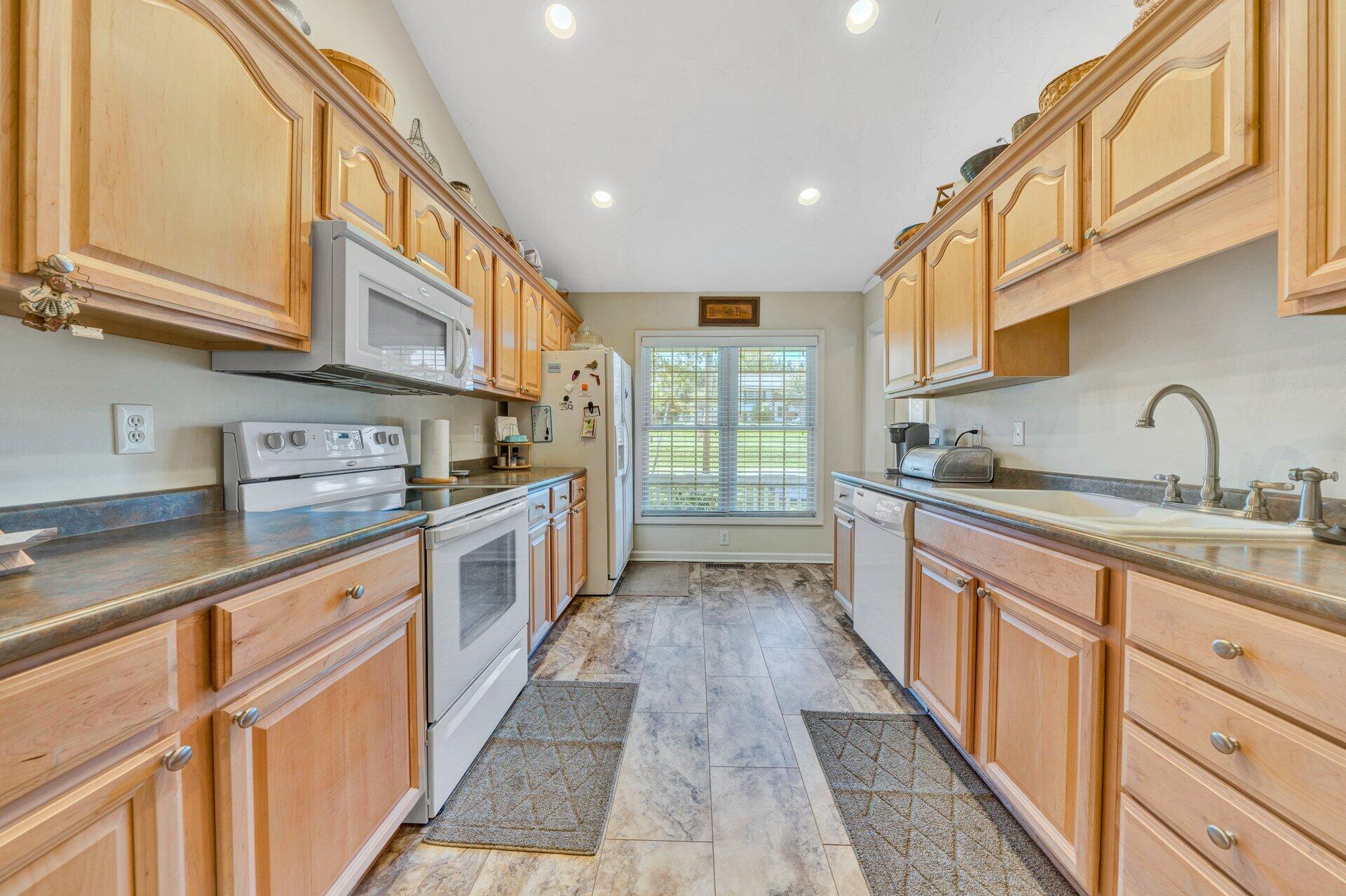 672 Kessler Mill Road Salem, VA 24153 - Photo 16 of 44 a kitchen with granite countertop a sink and cabinets