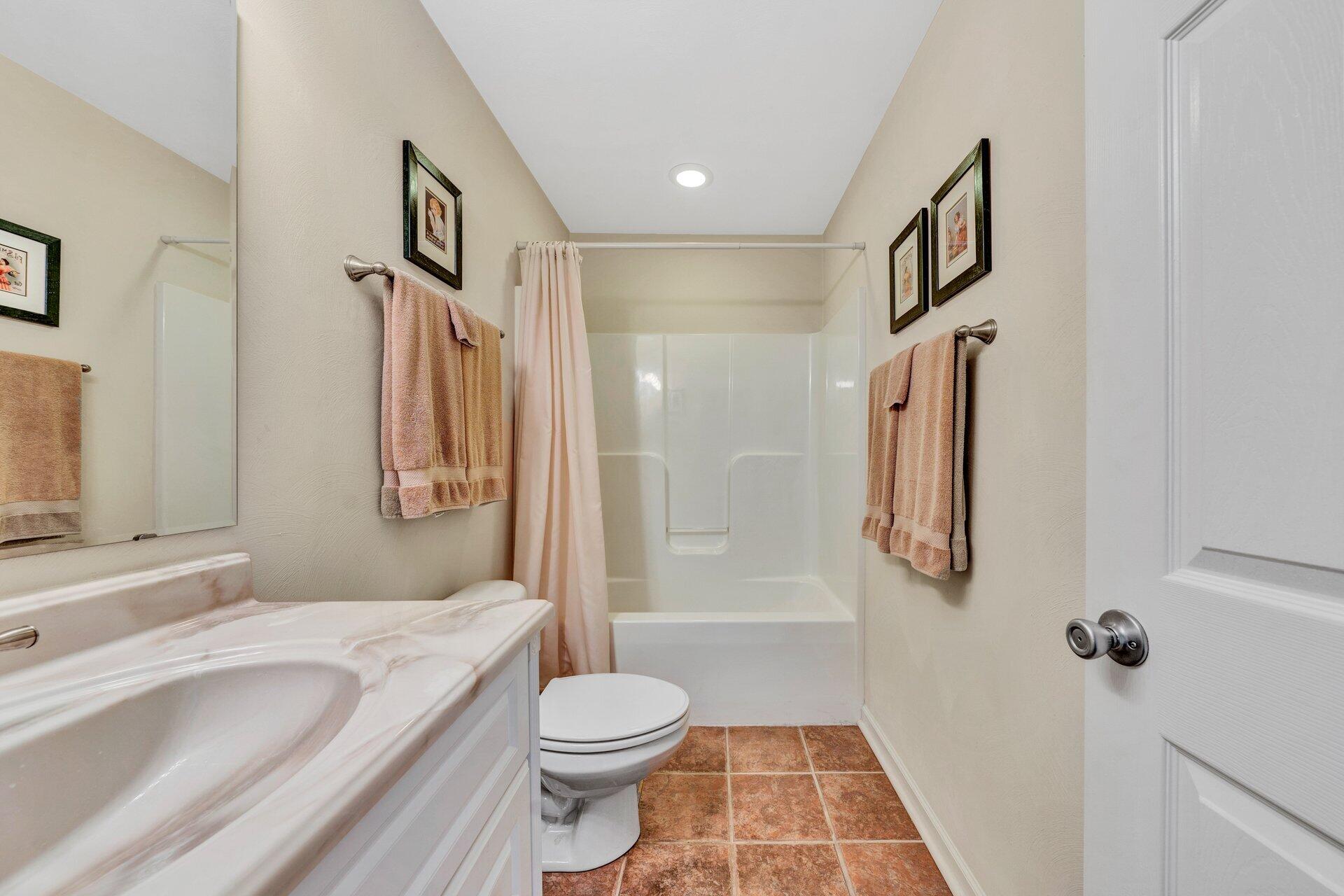 672 Kessler Mill Road Salem, VA 24153 - Photo 24 of 44 a bathroom with a granite countertop sink toilet and shower
