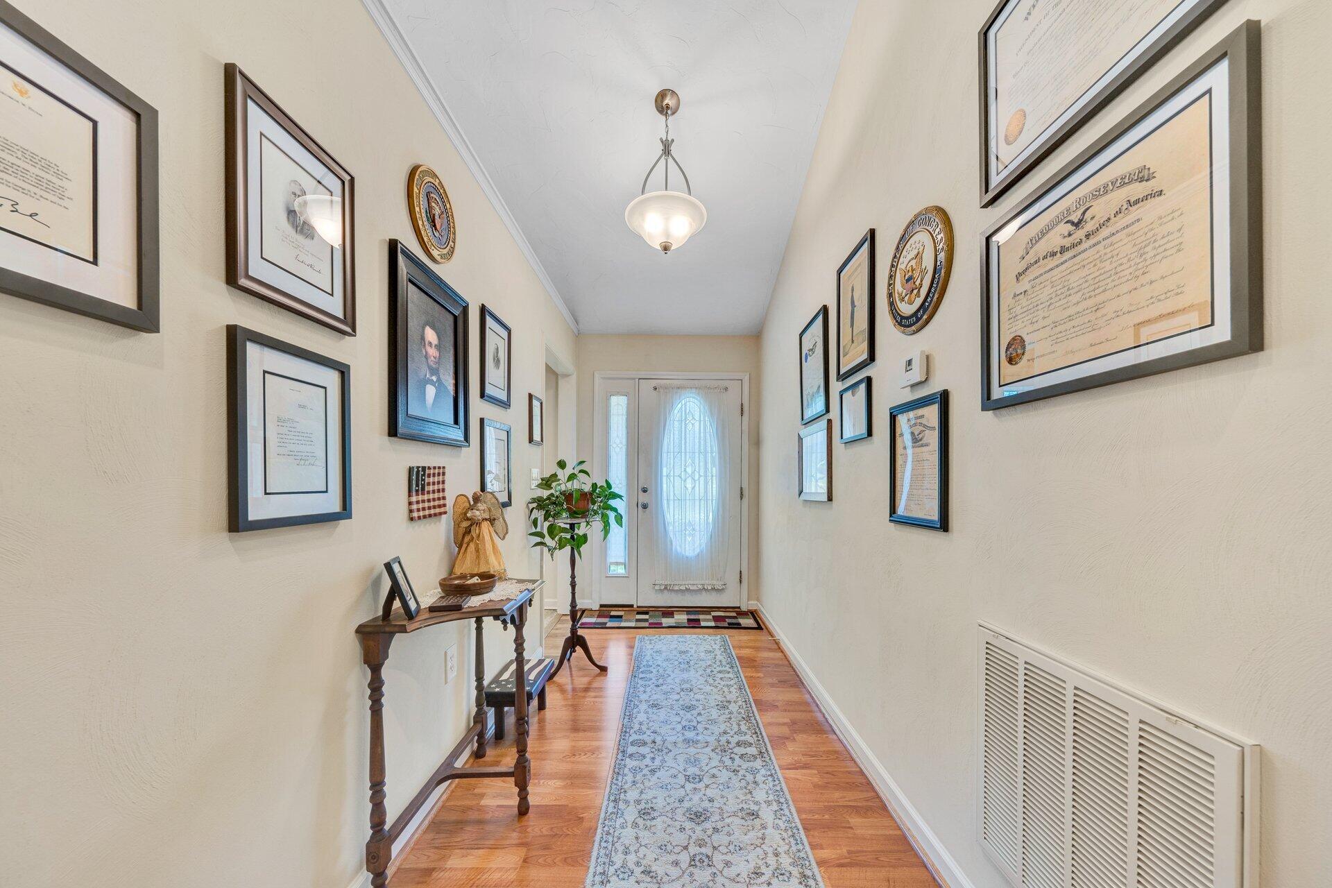 672 Kessler Mill Road Salem, VA 24153 - Photo 4 of 44 a view of a hallway with paintings on the wall