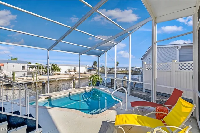 a view of a kitchen with a dining table chairs and chandelier