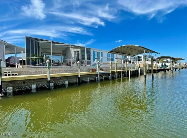 a living room with furniture a flat screen tv and a window