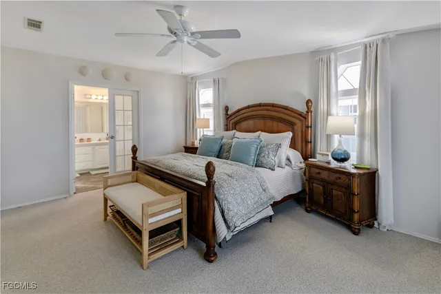 a living room with furniture a flat screen tv and a chandelier