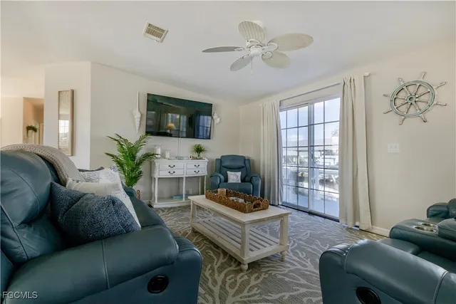 a view of a lake with couches chairs under an umbrella