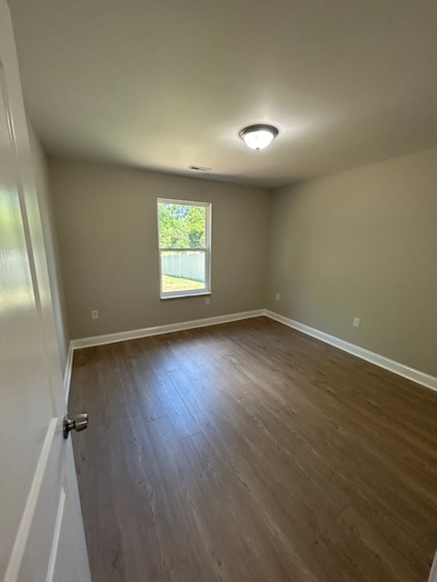 708 Hampton Street Iva, SC 29655 - Photo 11 of 14 This spacious room features ample natural light and durable flooring, offering a comfortable living space.