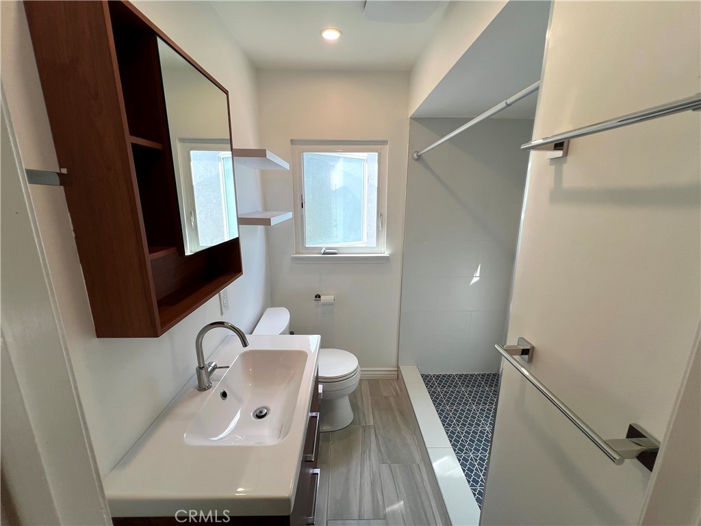 5835 Bowcroft Street, Unit 2 Los Angeles, CA 90016 - Photo 19 of 30 a bathroom with a sink a mirror and a toilet