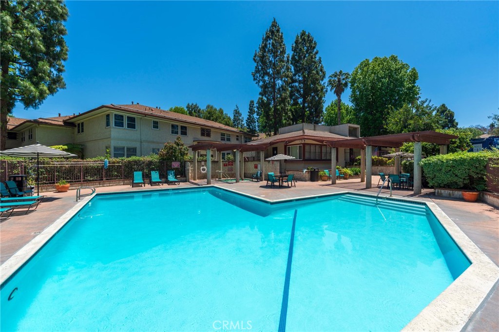 5835 Bowcroft Street, Unit 2 Los Angeles, CA 90016 - Photo 25 of 30 a swimming pool view with a seating space and a garden view