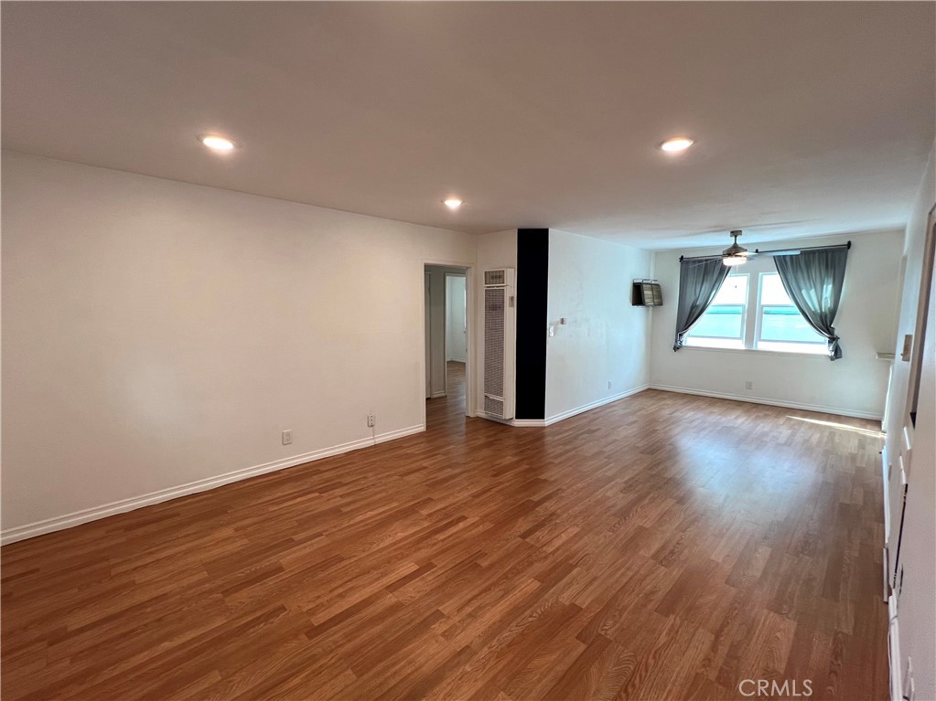 5835 Bowcroft Street, Unit 2 Los Angeles, CA 90016 - Photo 3 of 30 an empty room with wooden floor and windows