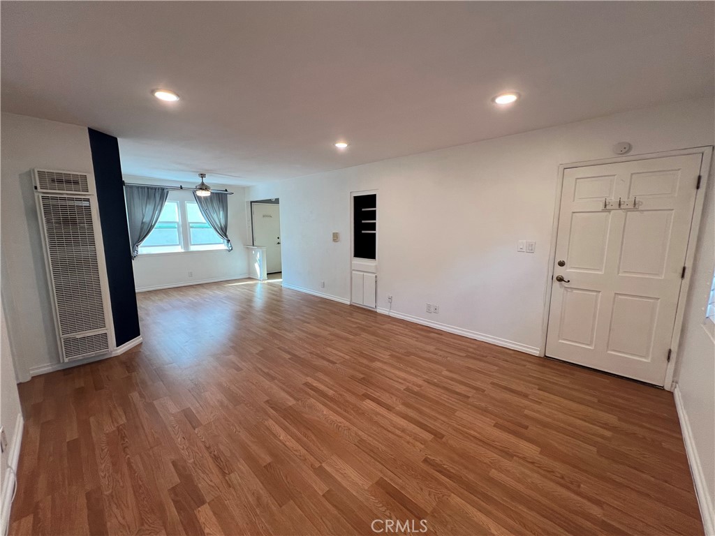 5835 Bowcroft Street, Unit 2 Los Angeles, CA 90016 - Photo 4 of 30 an empty room with wooden floor and a window
