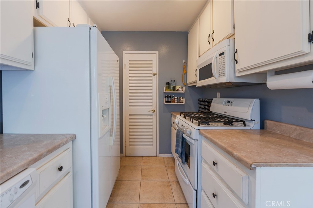 5835 Bowcroft Street, Unit 2 Los Angeles, CA 90016 - Photo 6 of 30 a kitchen with stainless steel appliances granite countertop a stove and a refrigerator